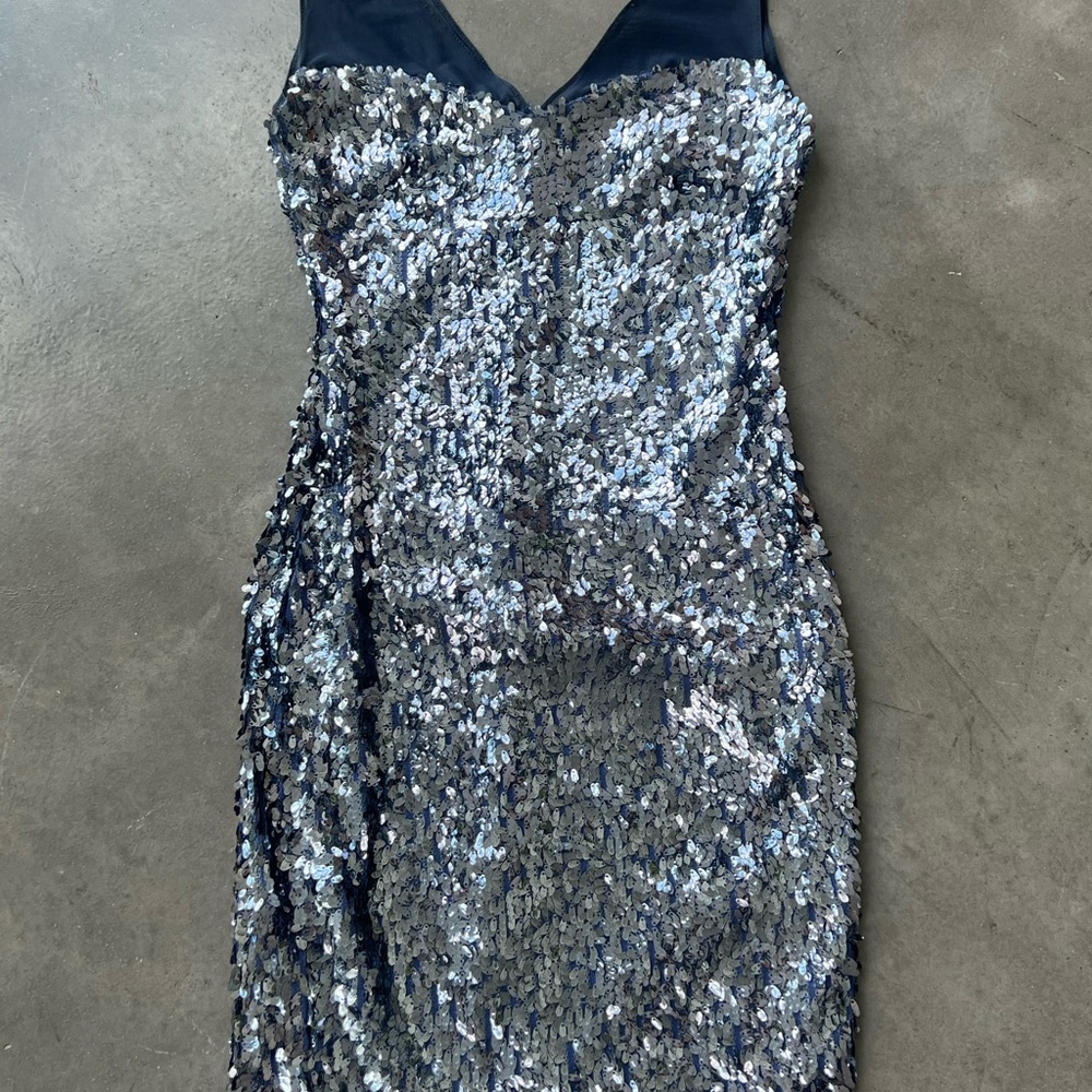 Navy blue sheer shoulder with sequins draped all around. Good stretch material.